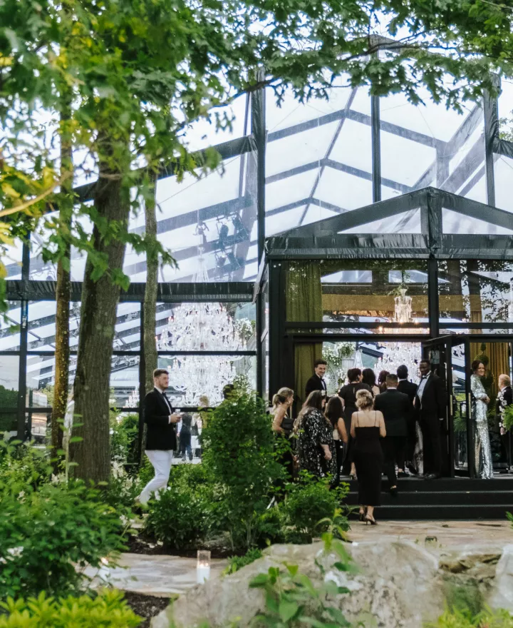 Guests file in to a greenhouse-style venue
