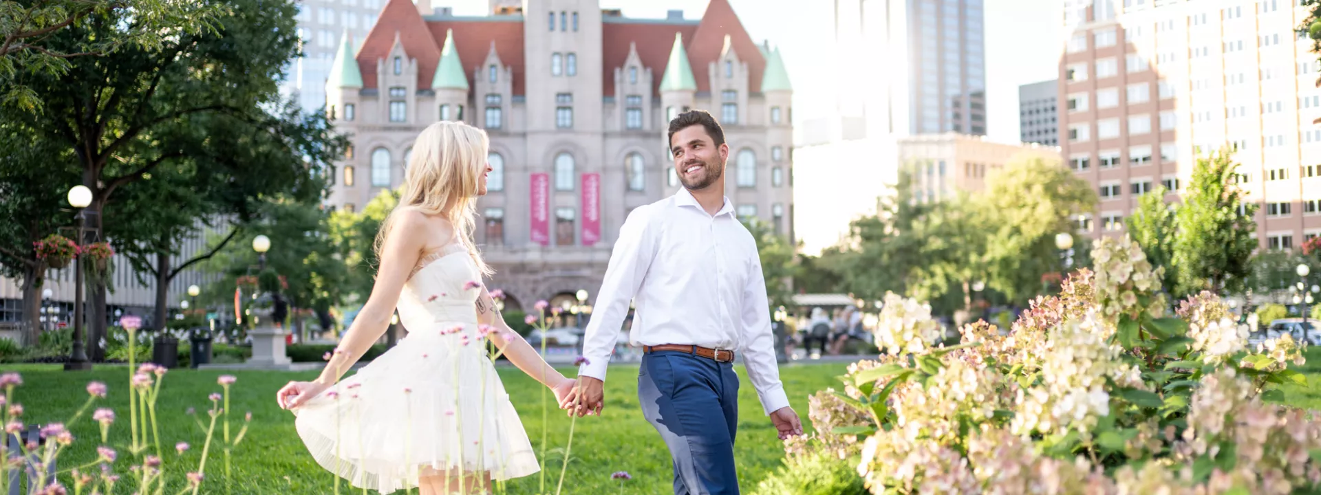 Katie and Zachary celebrate their engagement by prancing around the park in front of Landmark Center in St. Paul