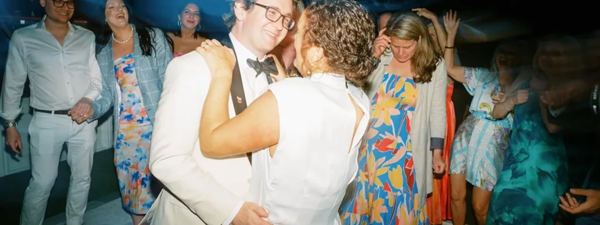Bride and groom embrace on the dancefloor of their wedding day at the Admiral's House