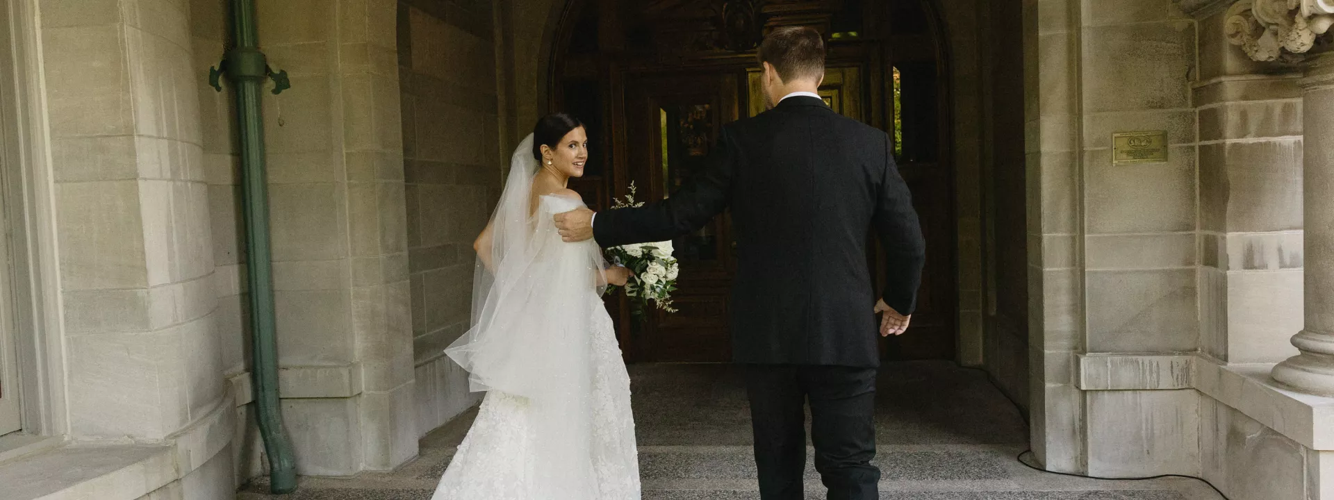 Bride and groom walking through the halls of the American Swedish Institute