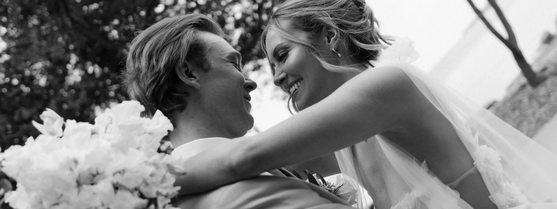 Bride and groom embrace on the grounds of Alpine Resort
