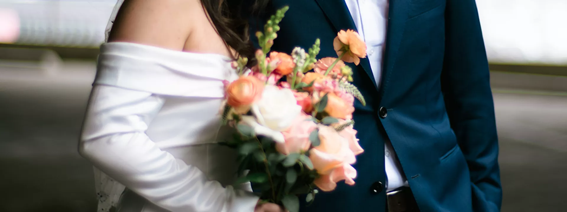 Bride Holding Bouquet and Resting Head on Husband's Shoulder