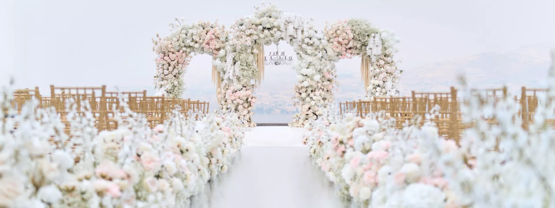 Lush all-white ceremony set up at Larc Hill Vineyard