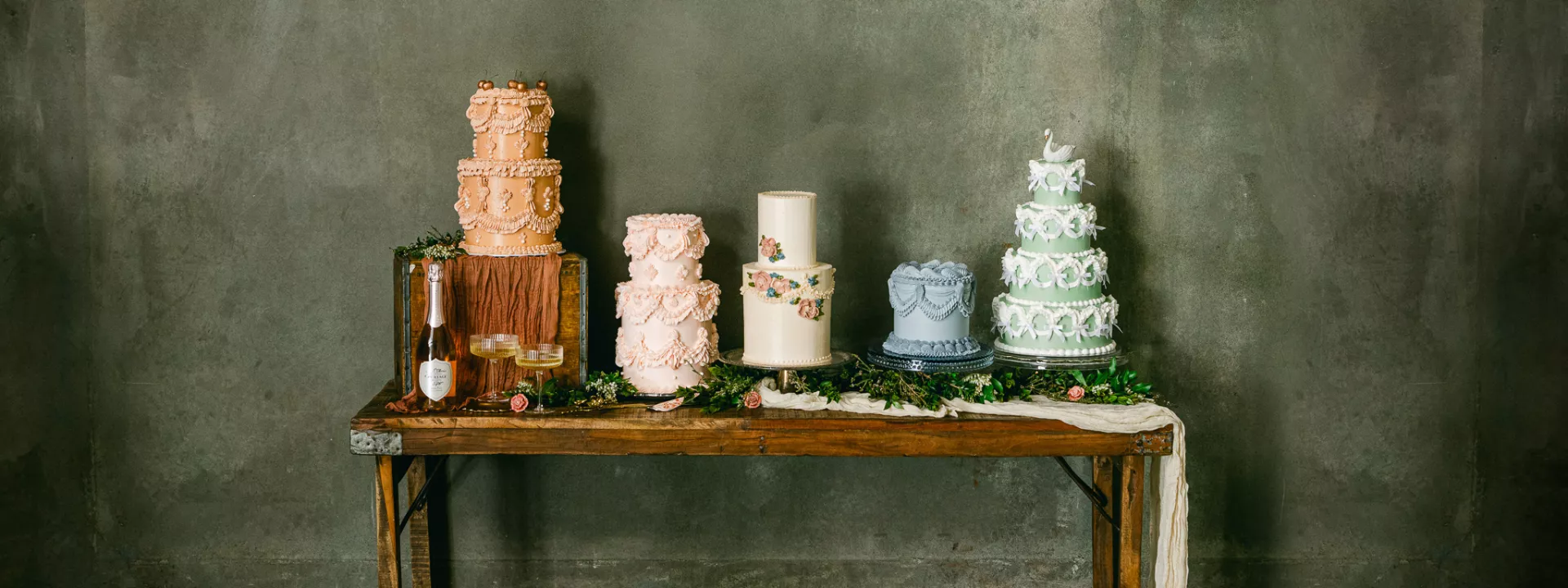 Five different vintage-style Lambeth cakes at wedding cake shoot with delicate details