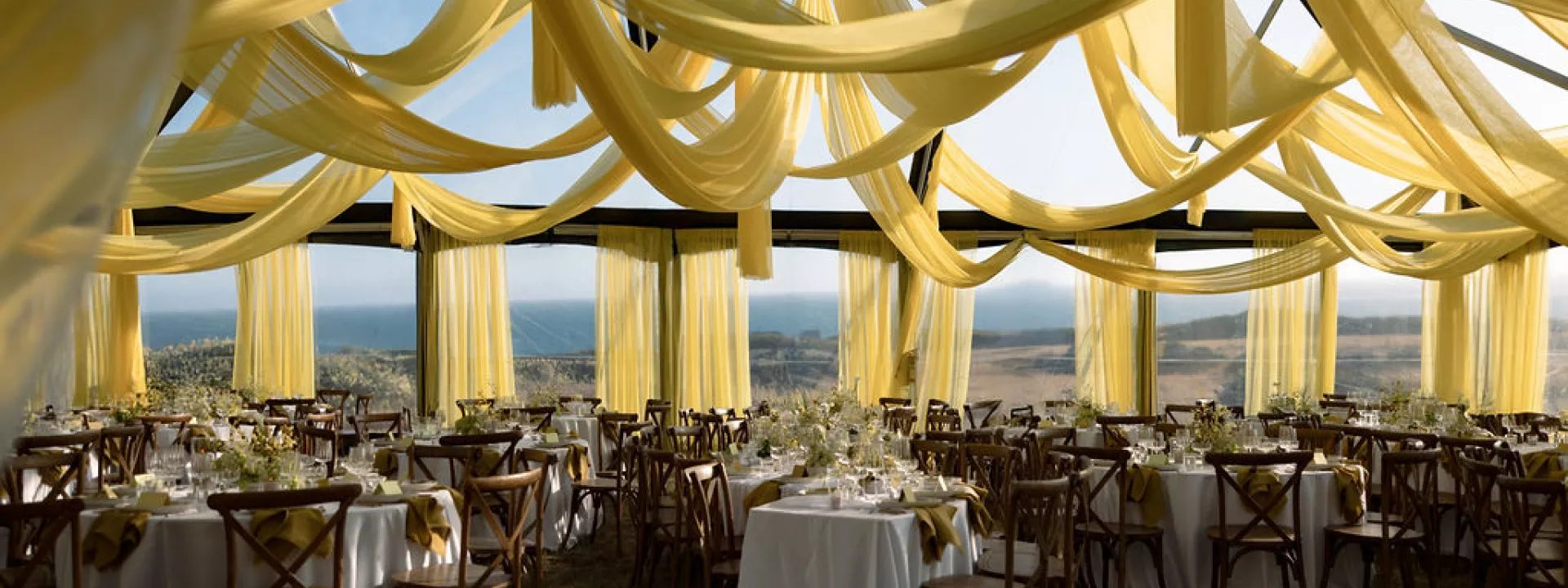 Bold chartreuse draping frames modern outdoor reception dinner at The Sea Ranch Lodge