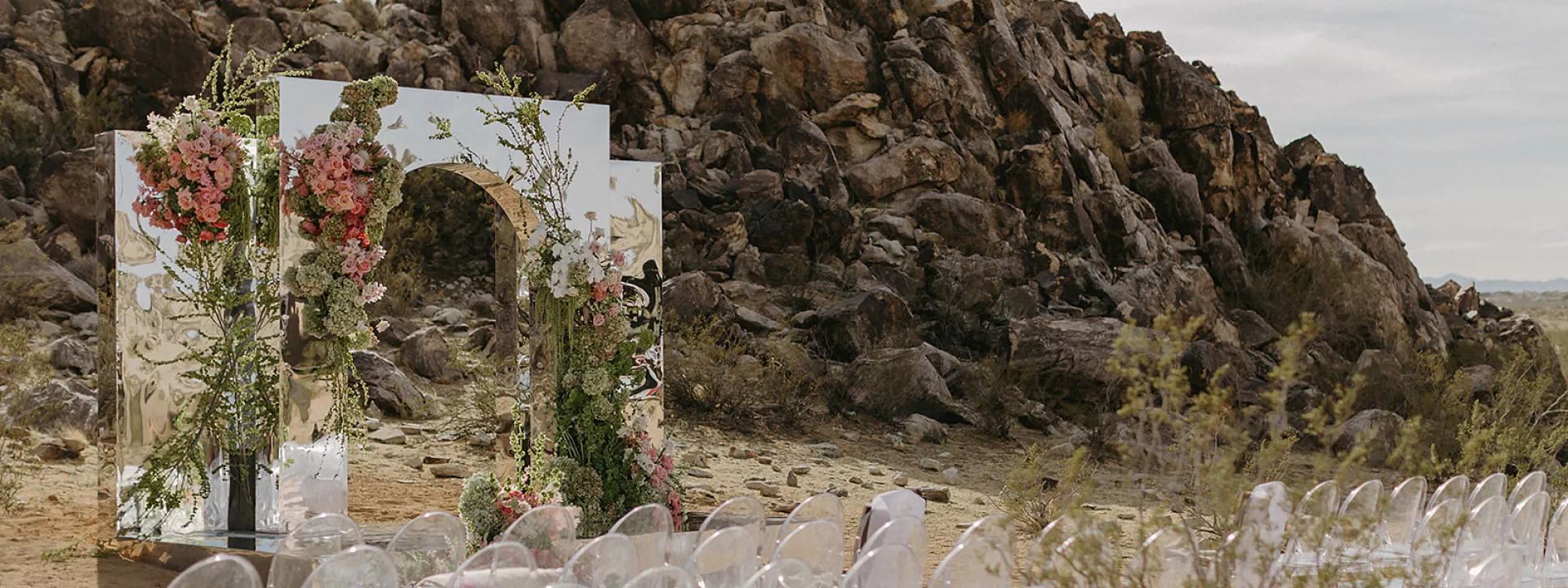 Eclectic desert ceremony space with mirrored altar and vibrant florals at Morada in Joshua Tree