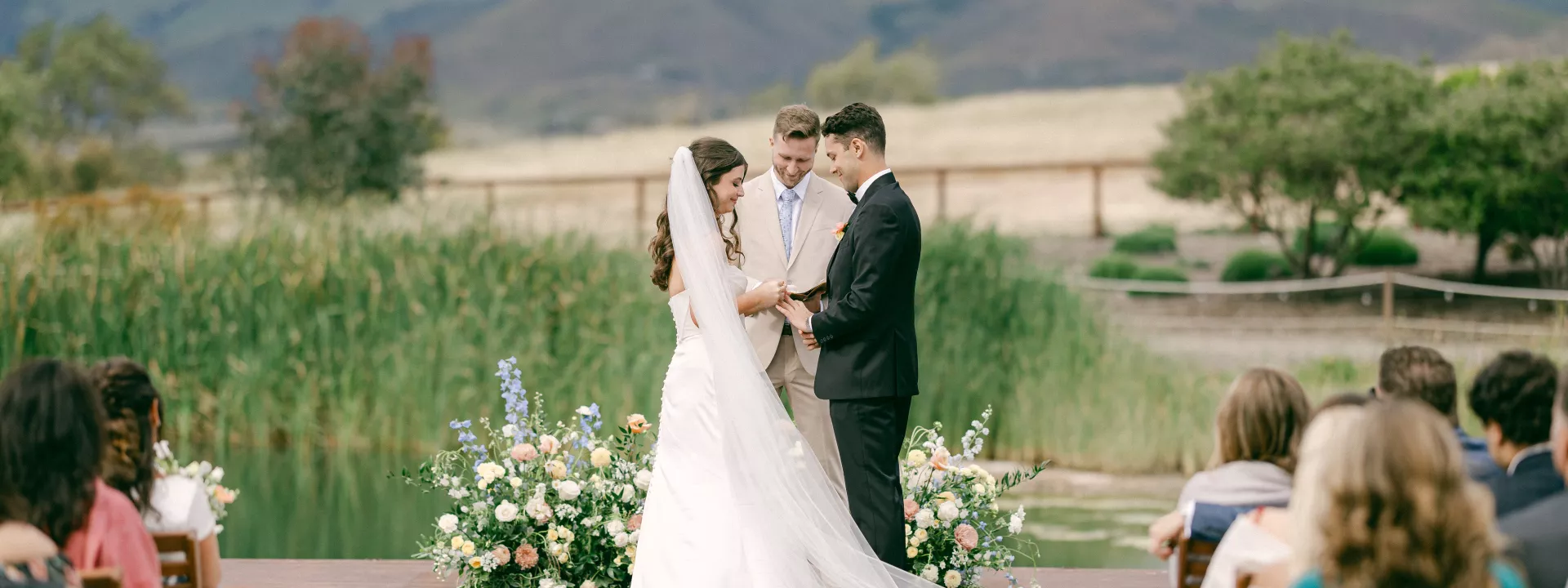 Bride and groom at the altar during their ceremony against the scenic views at Cavalli Estates