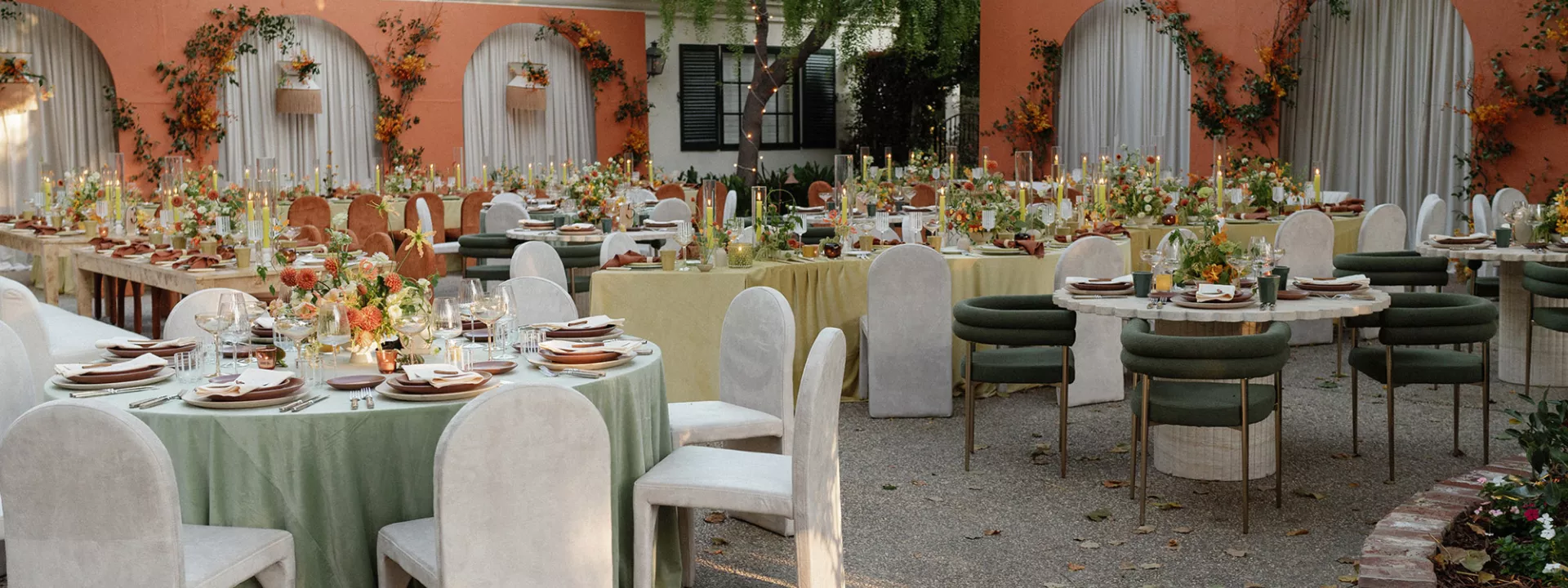 Mid-Century Modern reception scene featuring bold orange hues and serpentine table structures