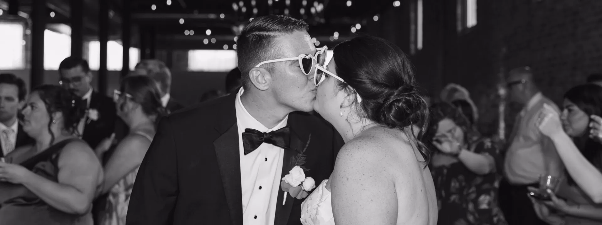 Bride and groom share a kiss during their reception at Mercantile Hall