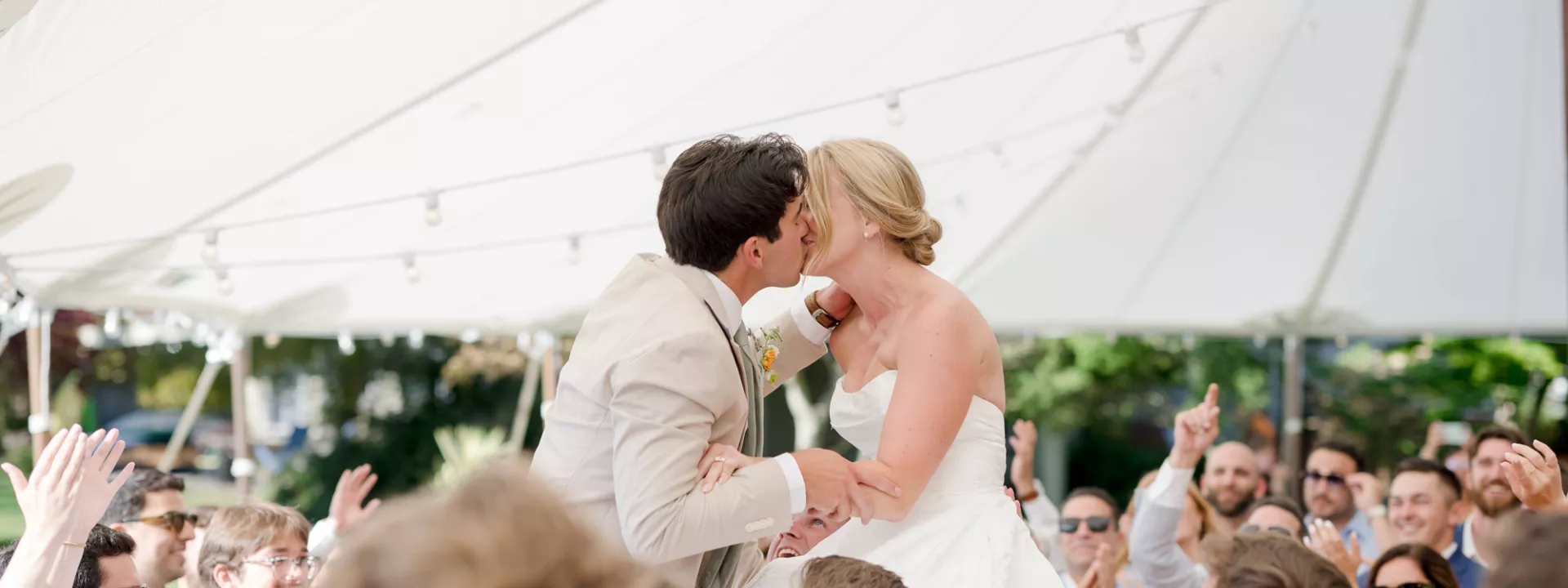 Courtney and Alden share a kiss as they are lifted into the air on the dance floor