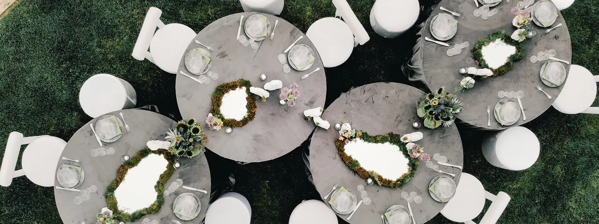Aerial view of reception tablescape featuring storm-grey hues and mirrored details at Grand View Malibu