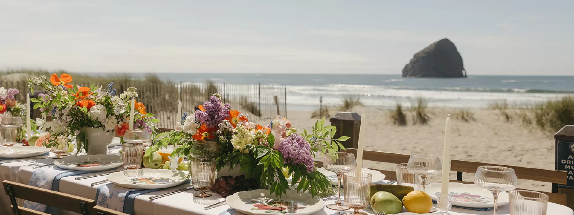 Minimal beach reception scene with bright florals and fruit accents at Pelican Brewing