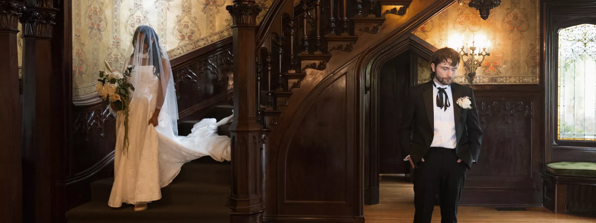 Bride descends staircase at Joslyn Castle to meet her groom in first look reveal