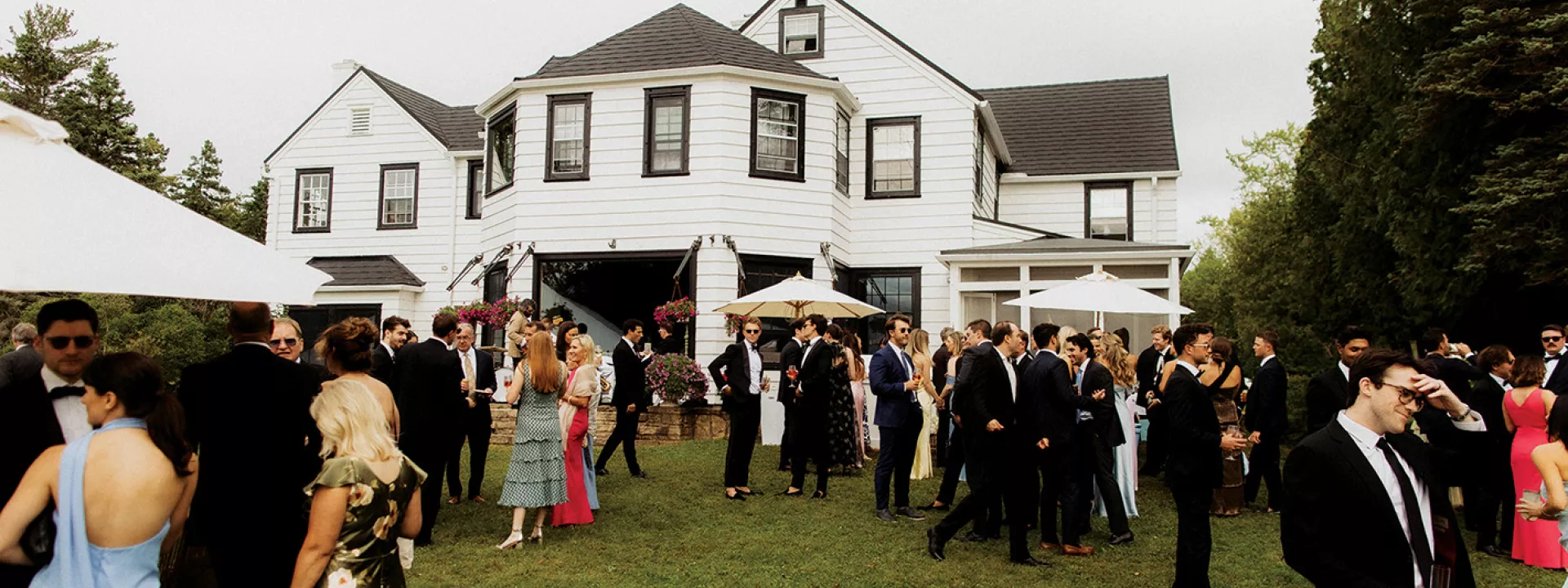 Lively cocktail hour unfolds on the back lawn of the Island Estate on Madeline Island