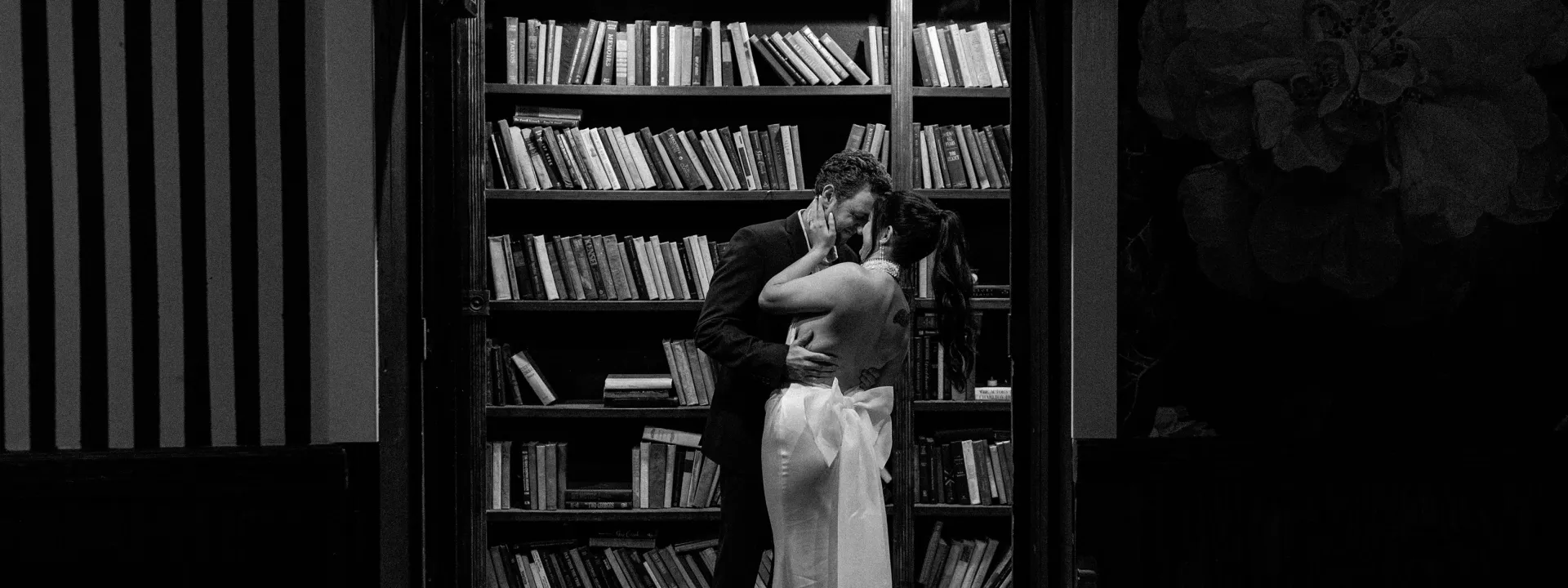 Bride and groom embrace in a library in fashionable wedding day at Ever After Ranch