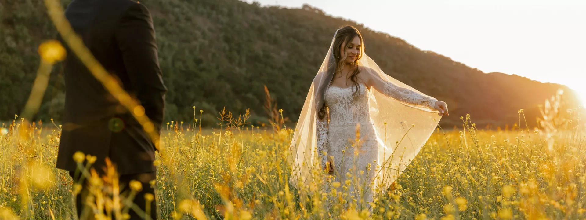 Morgan and Anthony pose in the mustard field of Tar Creek Ranch on their wedding day