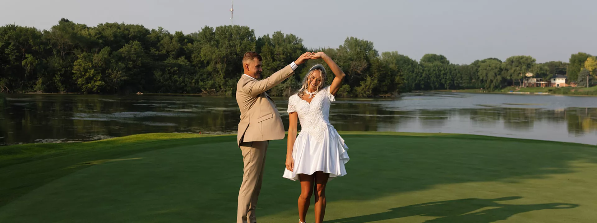 Groom twirls bride in mother's reworked bridal gown on golf course at rehearsal dinner
