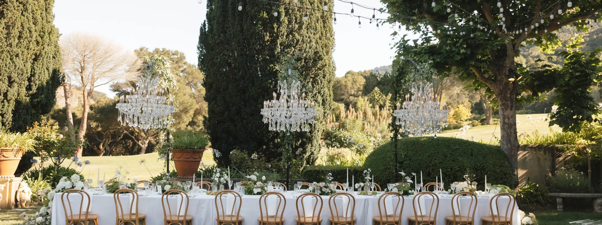 Ariel and Kiefer's lush al fresco reception featuring hanging chandeliers on the grounds of Stonepine Estate