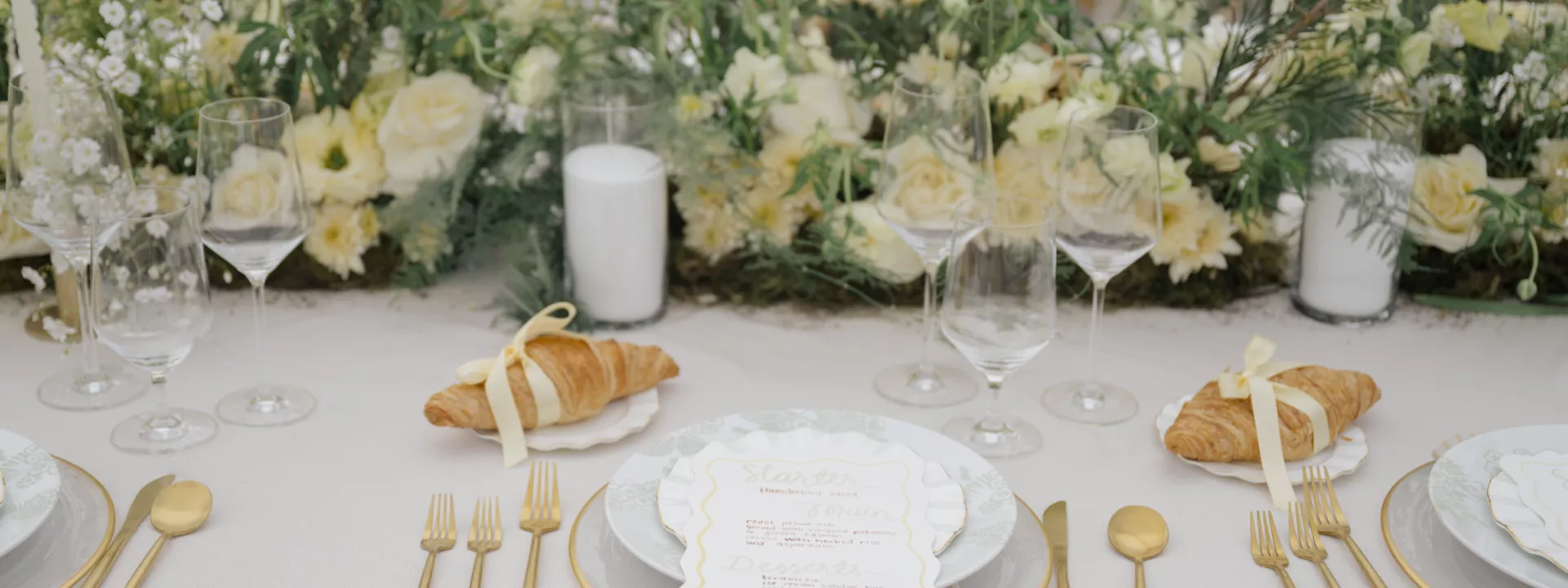 Butter yellow tablescape featuring lush florals and croissant details at Zenia