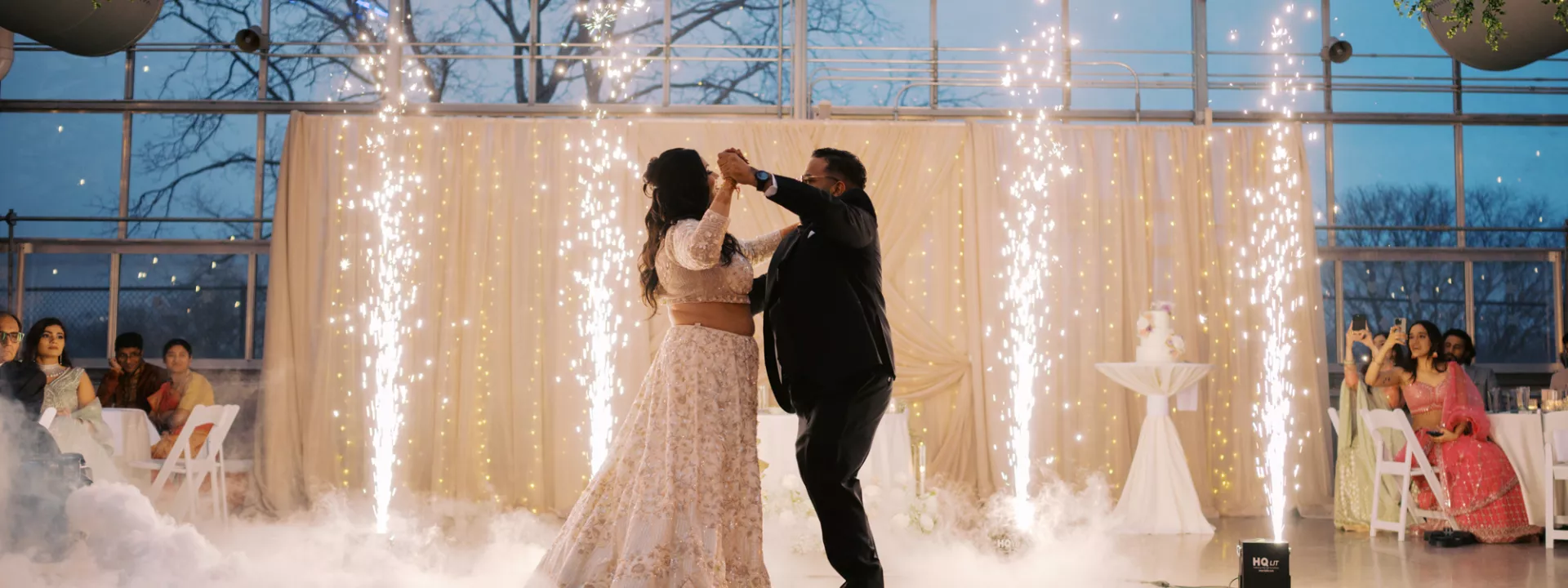 Bride and groom share their first dance accompanied by fog and cold sparks 