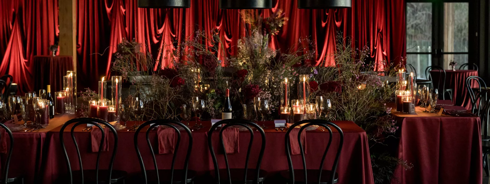 Rich red monochromatic reception scene at Amaterra Winery