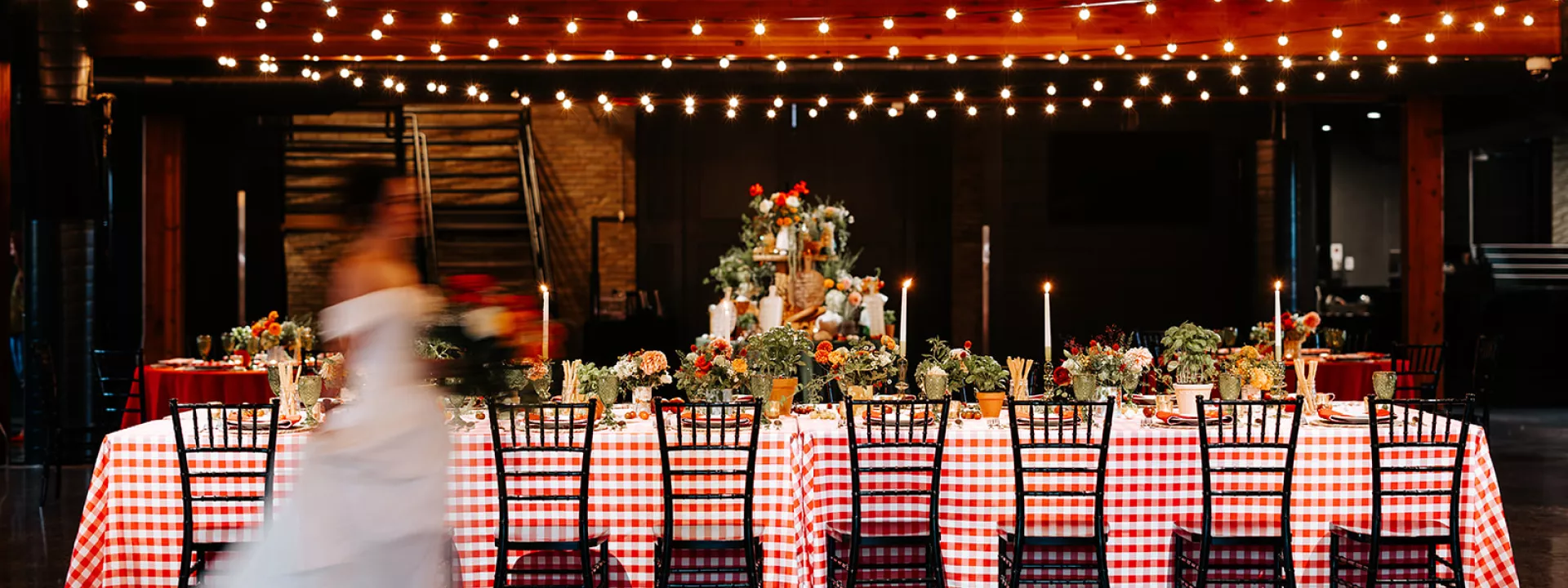 Cozy Italian restaurant-inspired reception featuring candlelight and produce infused tablescape at Essence Event Center