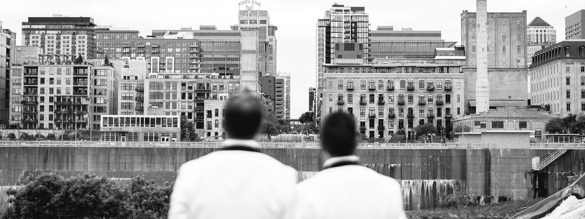 Matt and Luke lean on each other against the Minneapolis skyline
