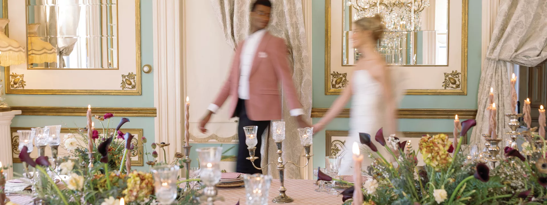 Models walk hand in hand amidst Ralph Lauren-inspired reception scene at Maxwell Mansion