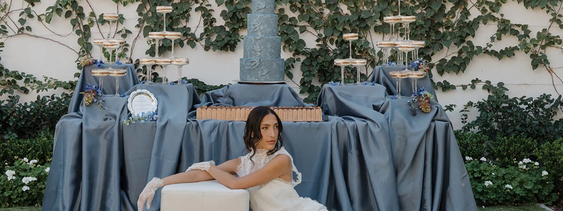 Model poses in front of a dessert table
