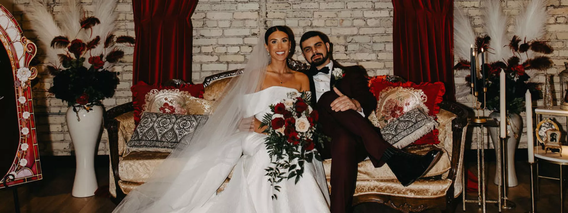 Kara and Jordan pose on a lounge vignette on their wedding day