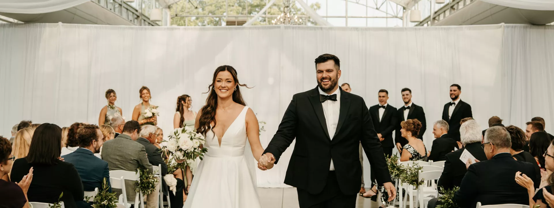 Lauren and Nathan walk back down the aisle after exchanging vows at Greenhouse No 7