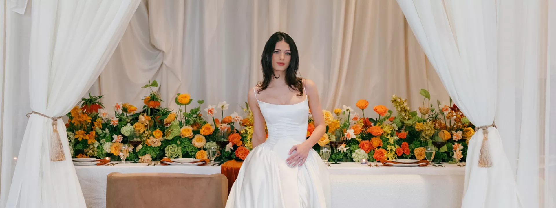 Model poses in front of boldly styled reception table at The Sentinel