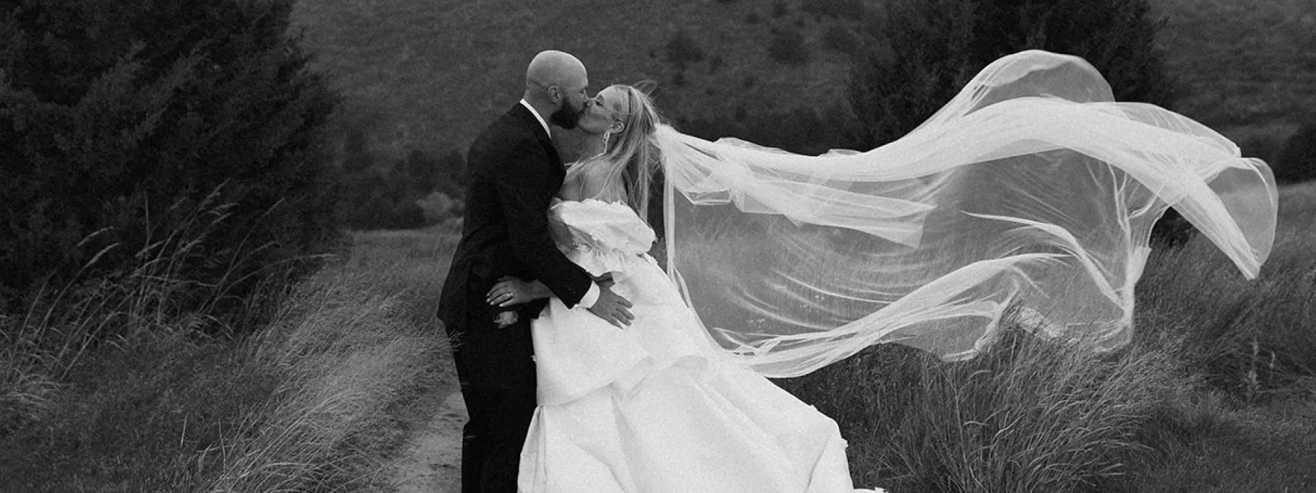 Jenni and Coby get caught in the rain during portraits at Dismal River Club