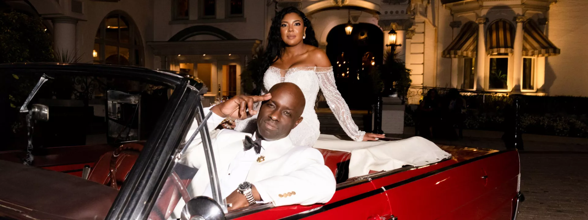 Marcelia and Renwick pose in vintage car outside of the Wisconsin Club