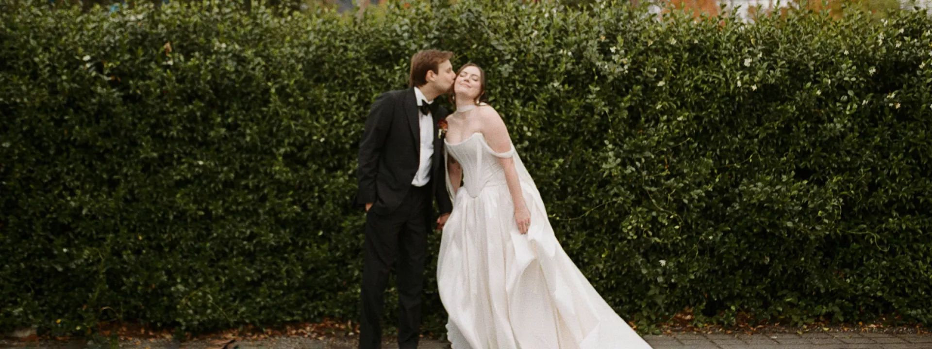 Allie and Max pose side by side on their wedding day