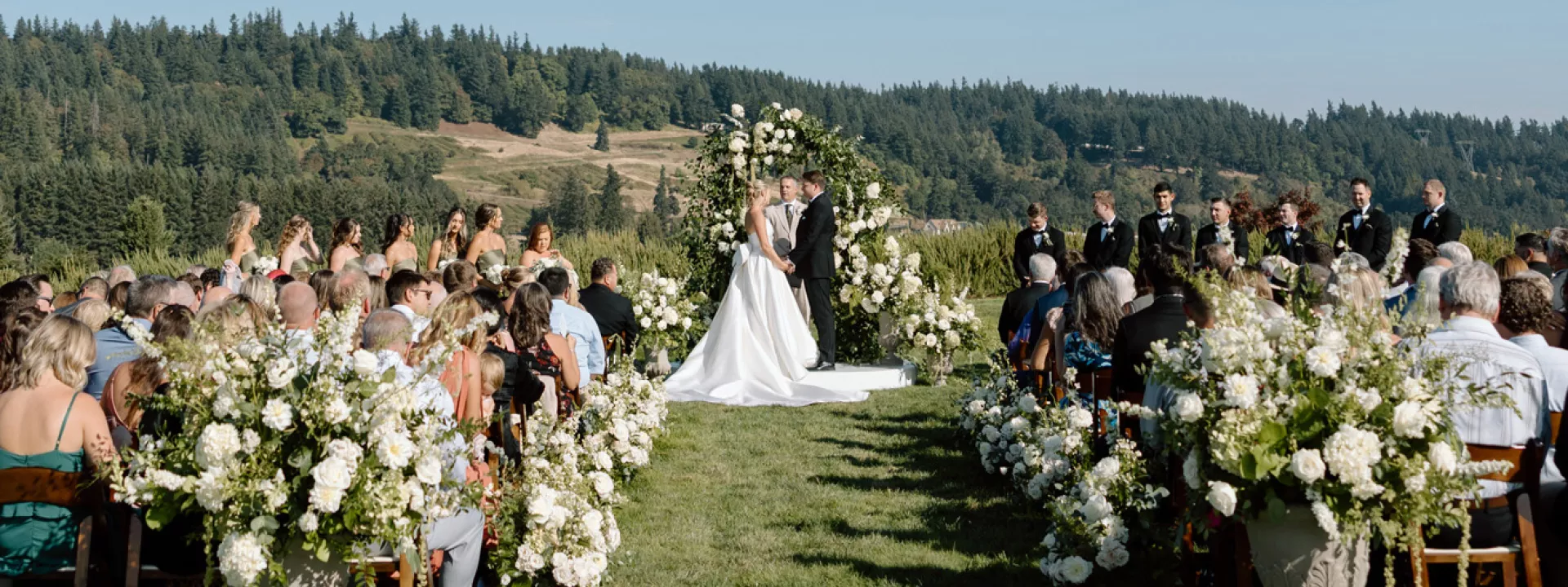 Lindsey and Scott stand at the alter in outdoor ceremony at Chateau de Harpe