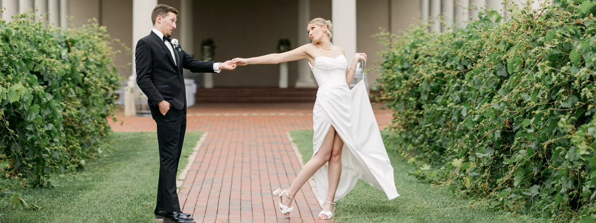 Layne and Nick pose in their wedding attire on the grounds of  Villa Bellezza