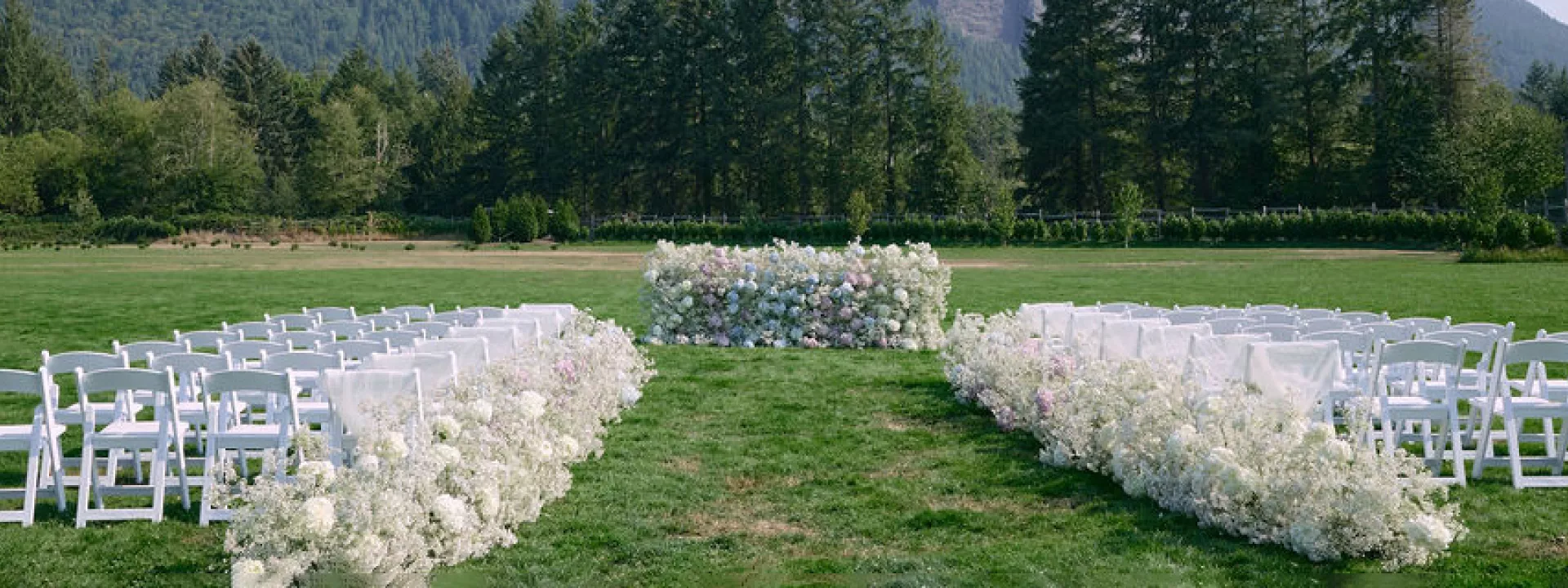 Outdoor ceremony with airy florals at North Fork Farms