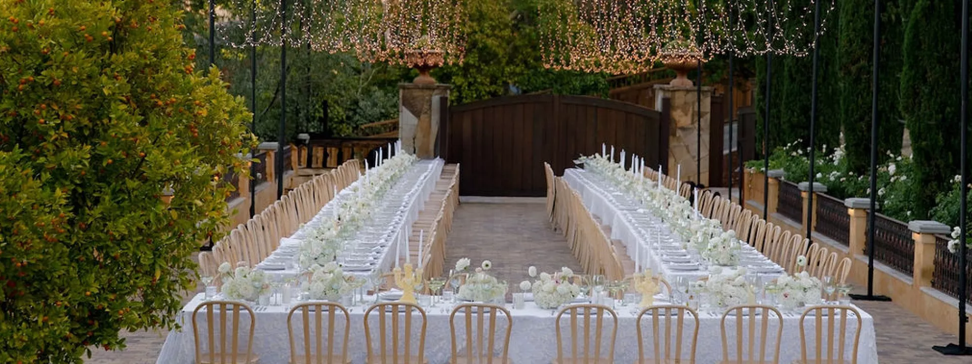 Outdoor reception scene with simple white décor at Private Residence