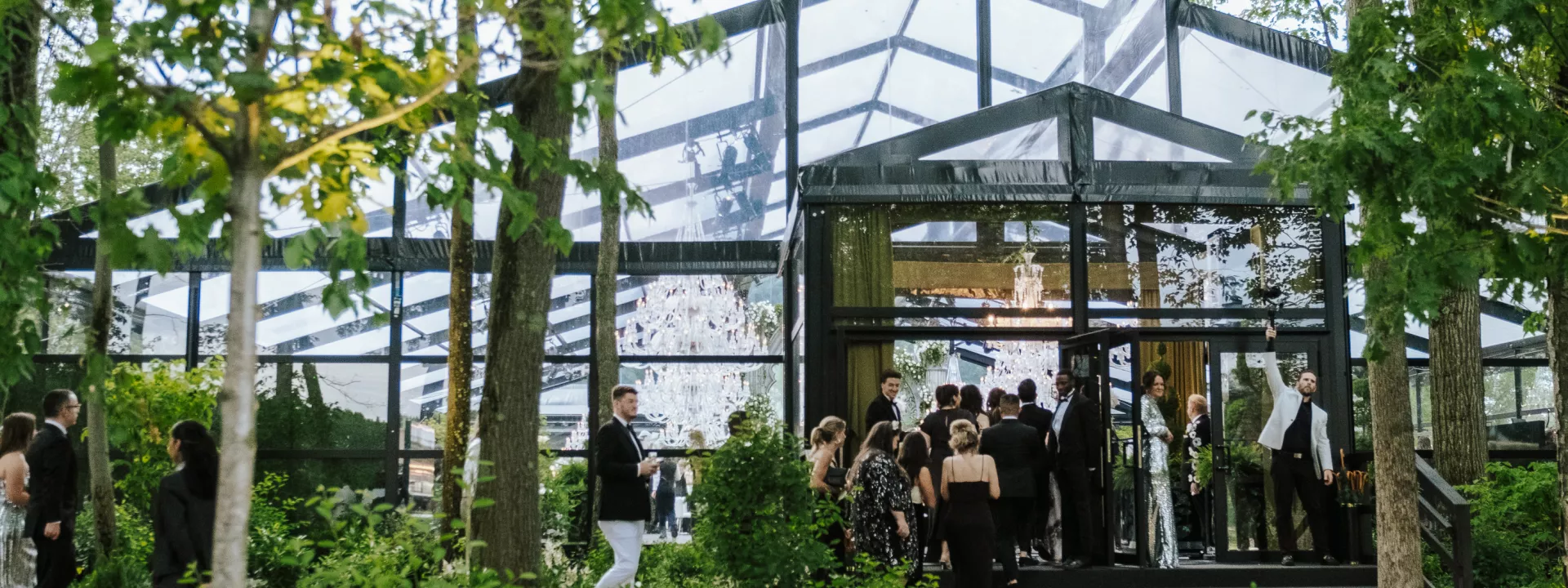 Guests file in to a greenhouse-style venue