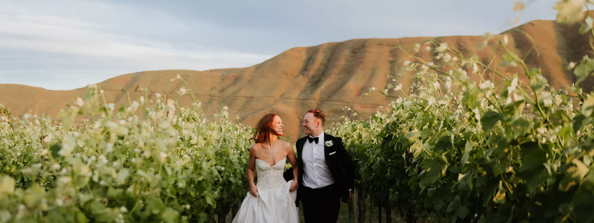 Lauren and Braedon walk on the grounds of a private estate on their wedding day