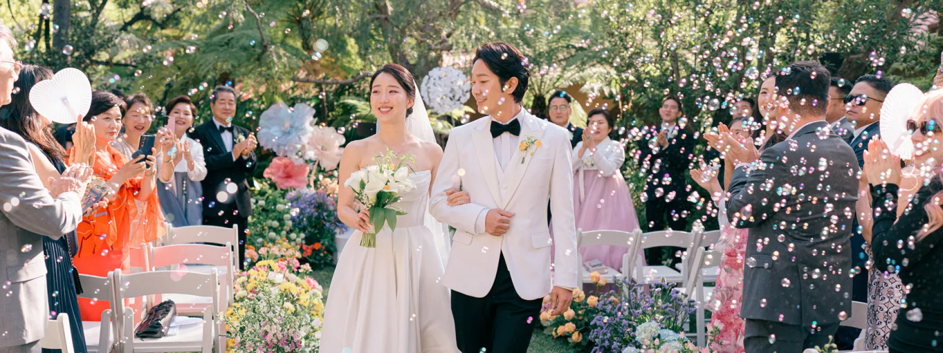 Bright flowers at the couple's outdoor ceremony set a stunning contrast to the darker, classical hues at the reception.