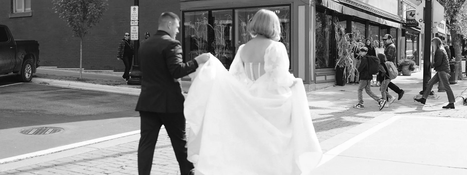 Josh Holds Caitlin's Dress as they Cross the Street in Northfield