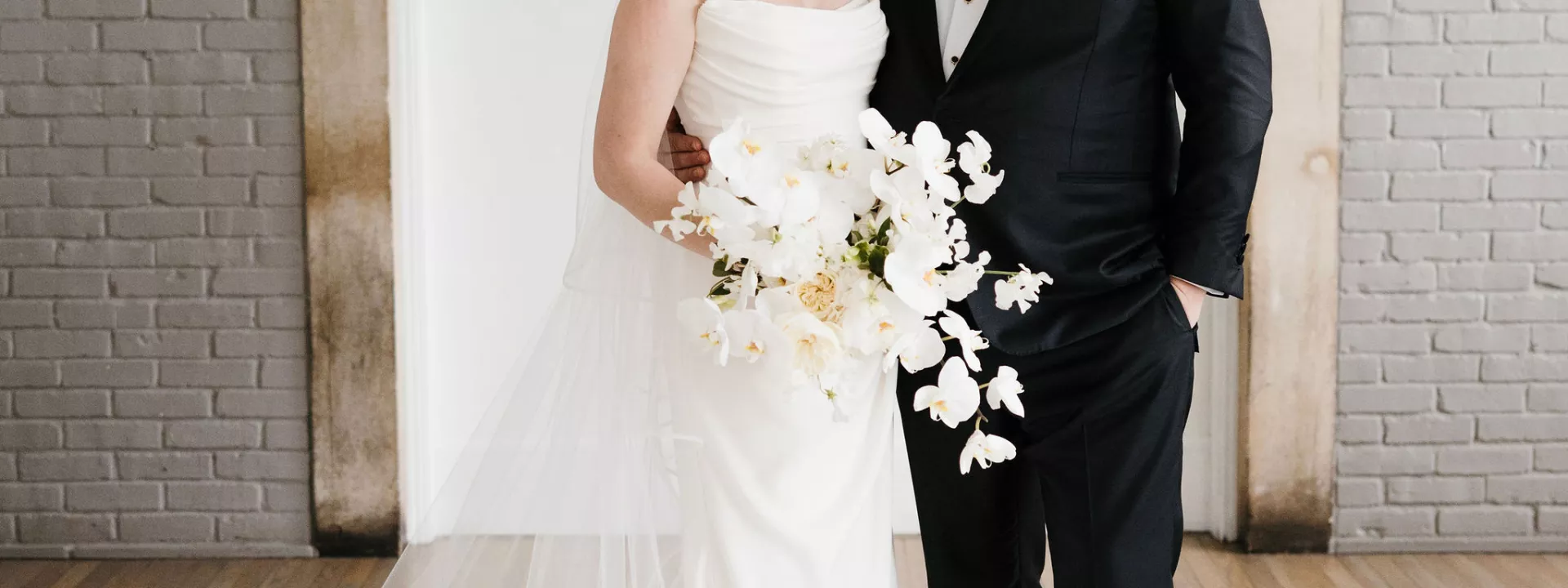 Paige and Johnnie standing in their wedding attire before heading to their ceremony. 