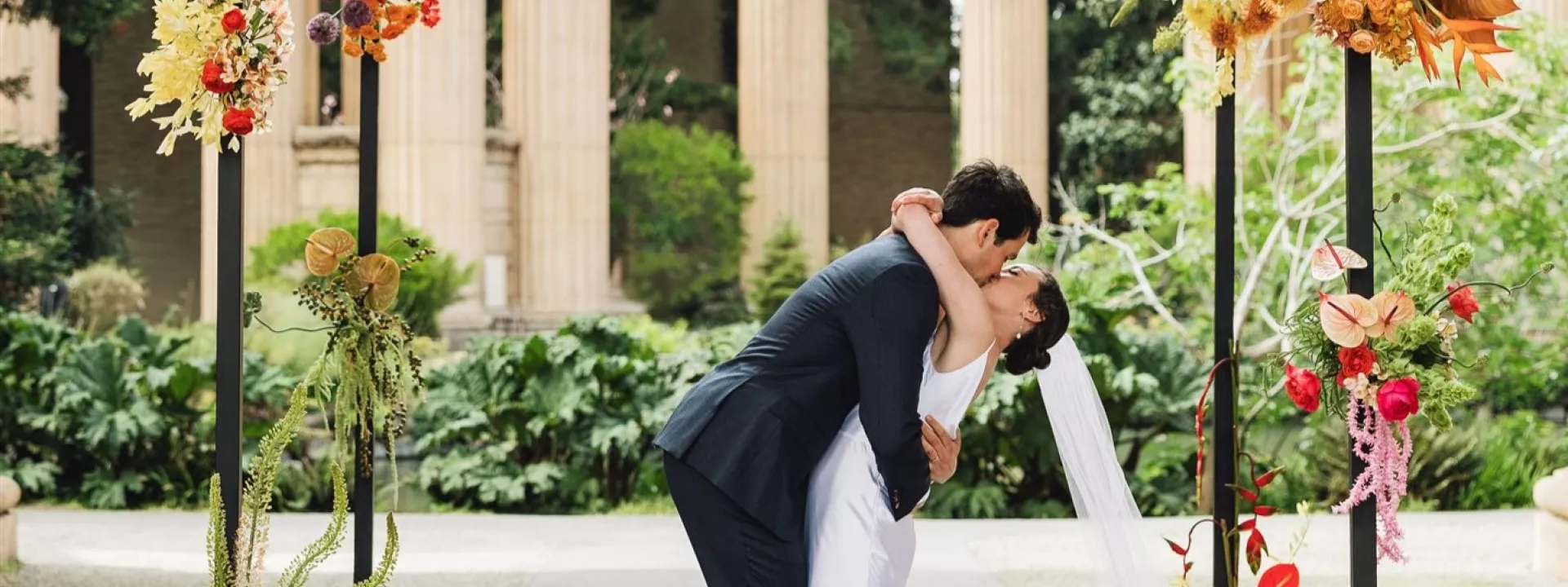 Bright colored florals decorate ecclectic wedding held under the roman rotunda at the Palace of Fine Arts