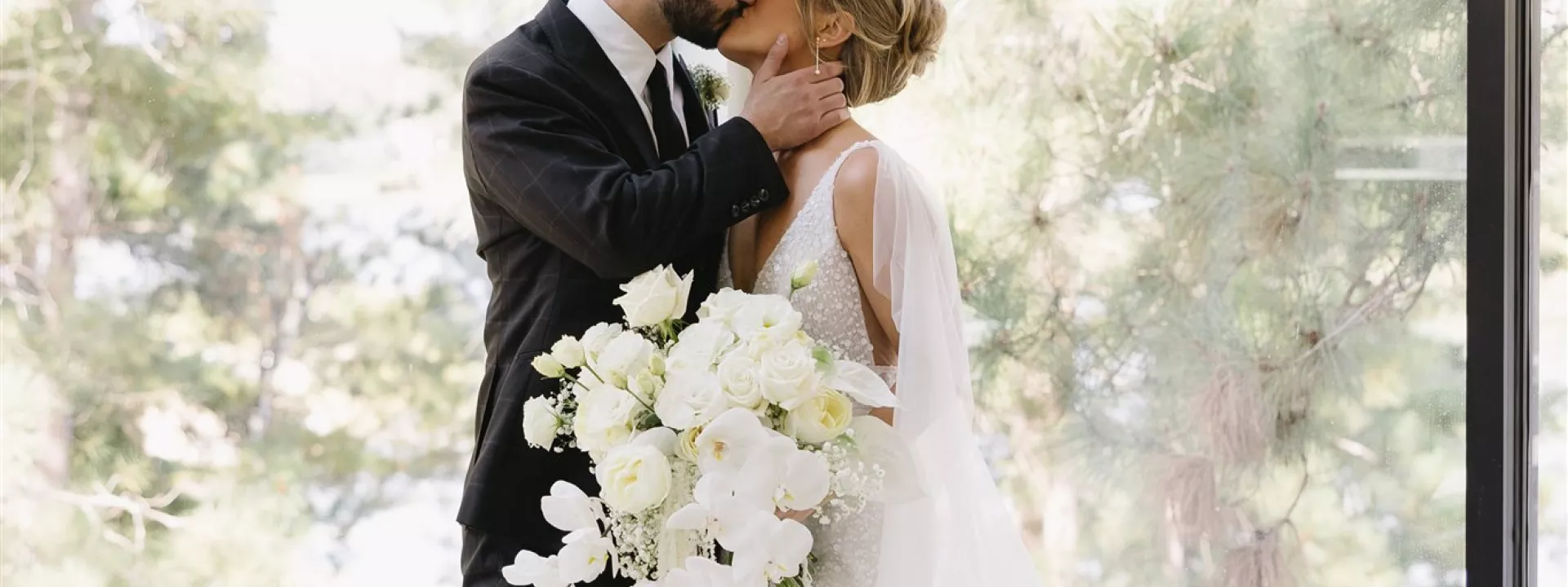 Bride and groom share kiss at modern venue