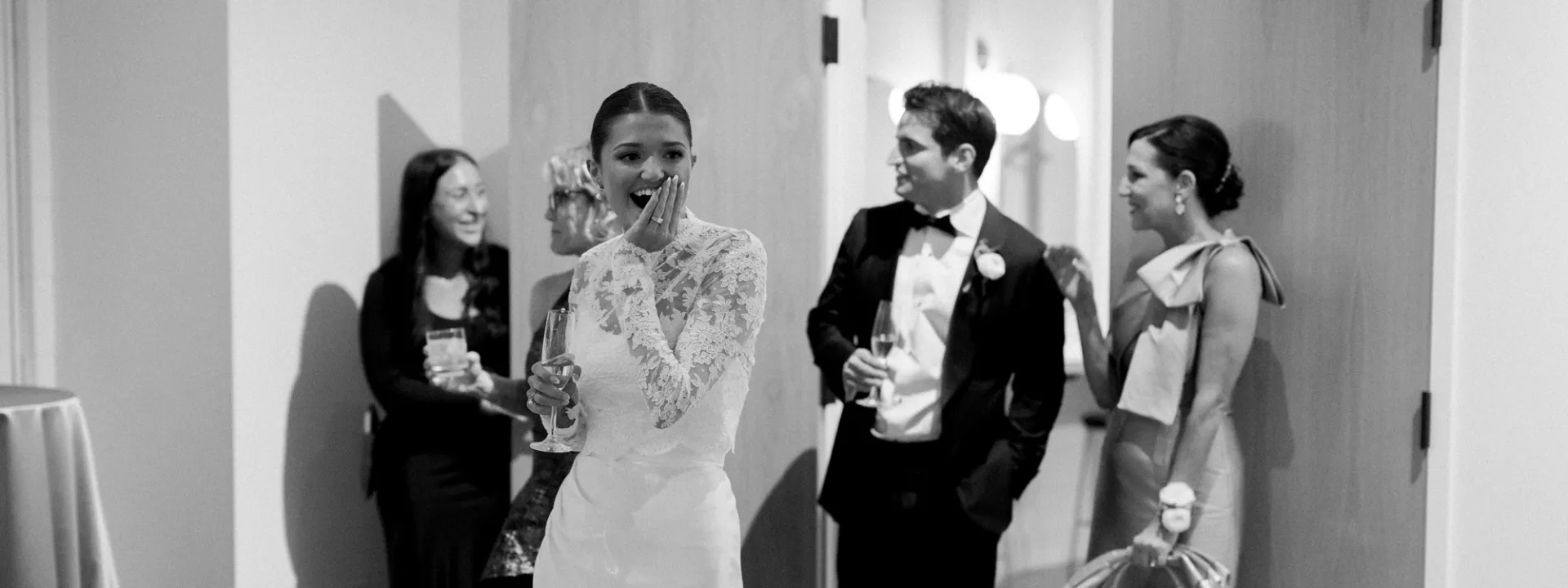 Bride and groom smile in suprise and awe of their wedding reception at The Whim
