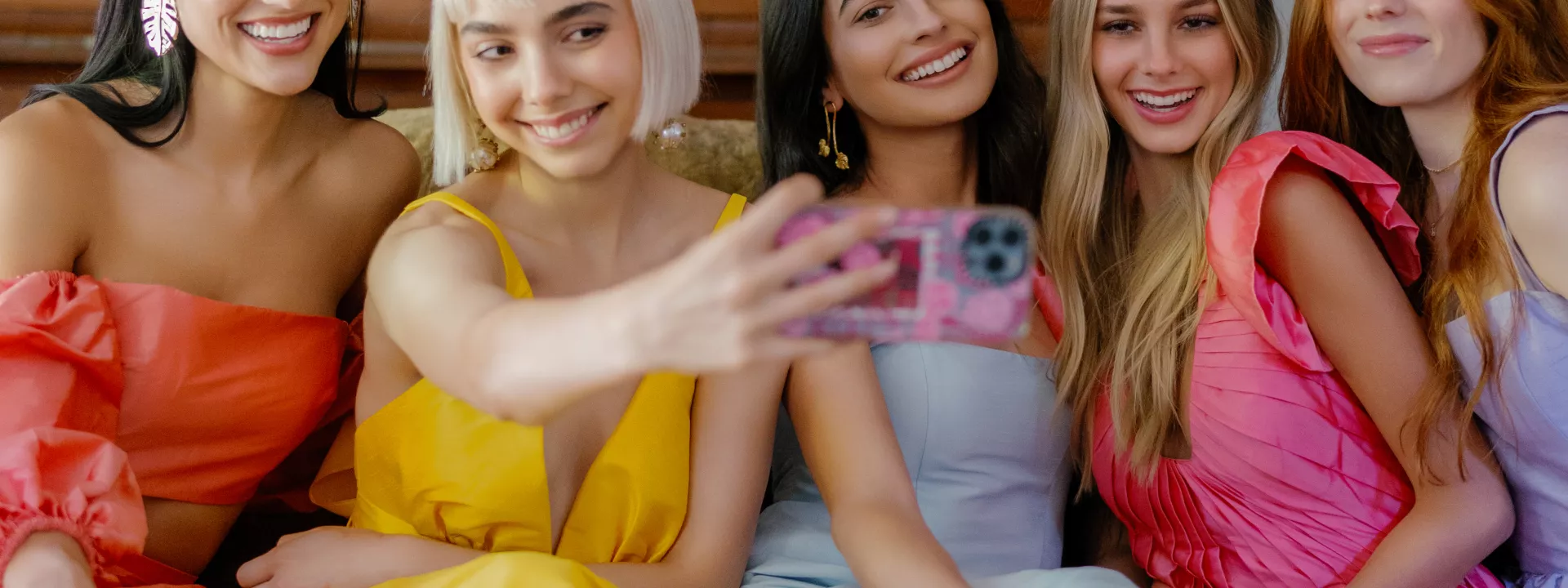 Models take a selfie in bright, summer-wedding-ready gowns by Watters