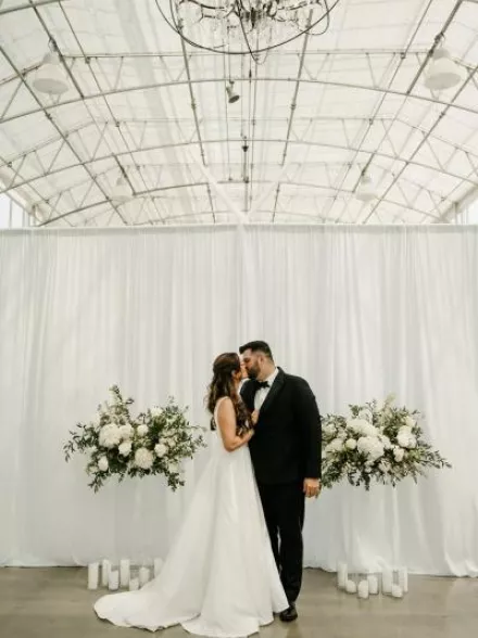 Lauren and Nathan share a kiss at the altar on their wedding day at Greenhouse No 7