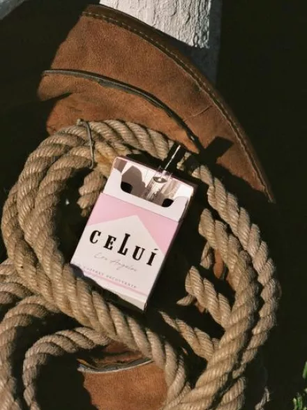 Celui promotional photo with fragrance pack sitting in a bundle of rope